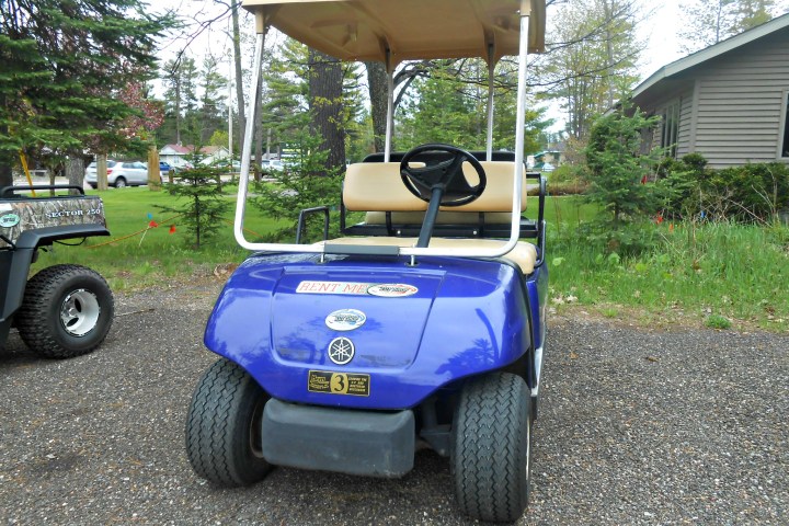 a blue car parked in front of a house