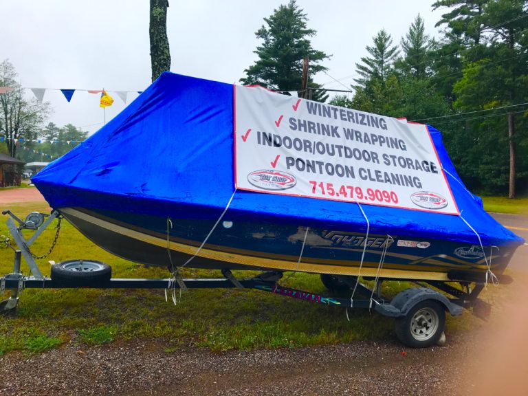 a small blue plane sitting on top of a grass covered field